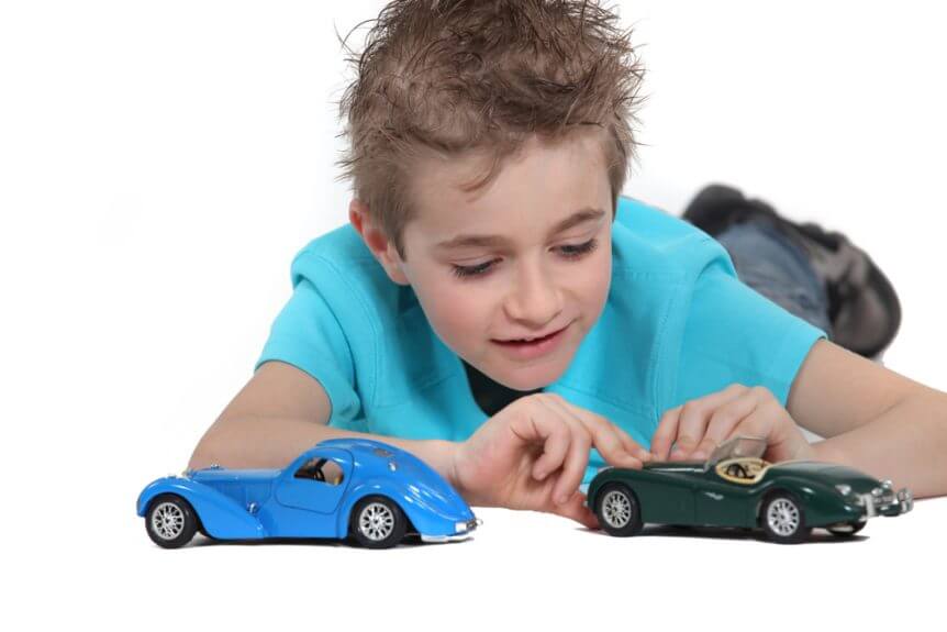 Child Playing With Toy Cars